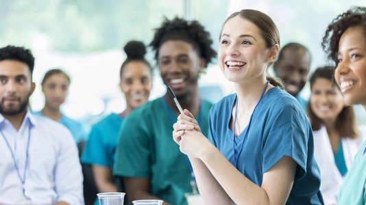 Cheerful Hispanic female nursing students smiles as she listens to a professor's lecture